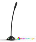Black wired computer microphone with 3.5mm jack, blow-out sponge, and stand on a desk.