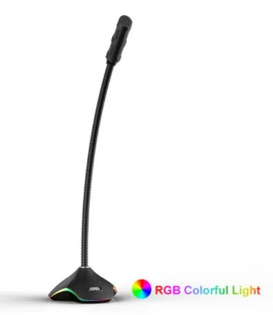 Black wired computer microphone with 3.5mm jack, blow-out sponge, and stand on a desk.