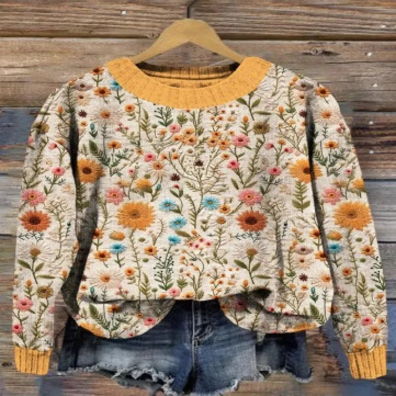 Women's little flower digital printed round neck long sleeve knitted sweater on a hanger.