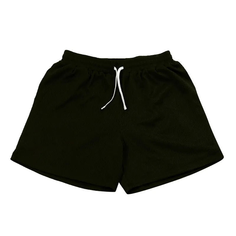 Men's solid colour quick-drying mesh sports shorts in black, shown for running.