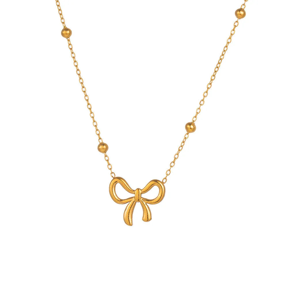 Gold bow necklace on adjustable cross chain for women