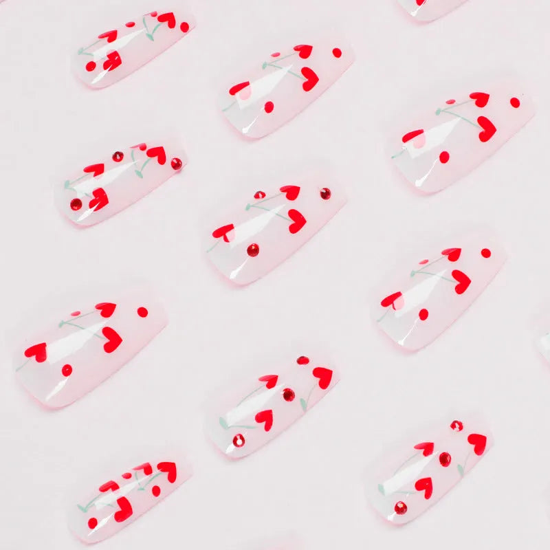 Set of 24 red cherry and diamond shaped nail art decorations for French manicure designs.