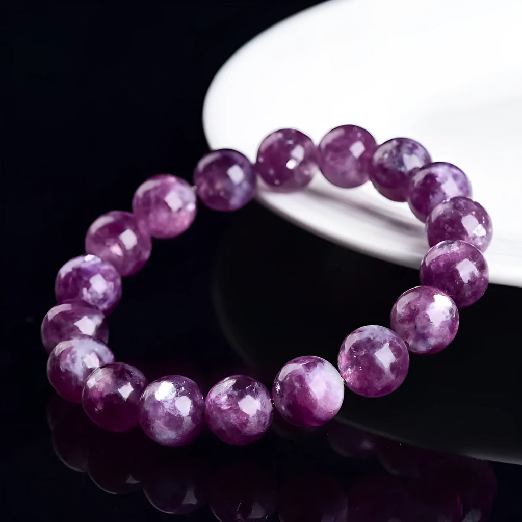 Grandmother crystal bracelet with polished geometric beads in purple on a wrist.
