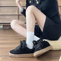 Retro black low-top sneakers on a waterproof platform sole with round toe and lace-up front.