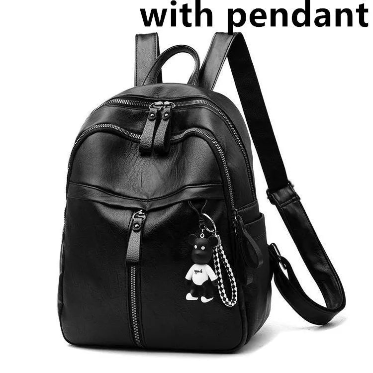 Black soft-surface pu leather backpack with double straps and luggage strap, showing main compartment.