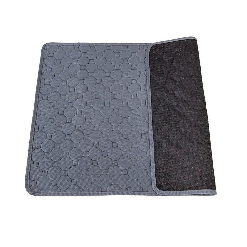 Tan and grey washable dog pee pad on a wooden floor, measuring 18 by 24 inches.