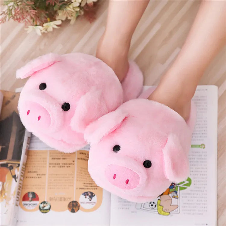 Pink pig-shaped plush floor slippers for indoor use.
