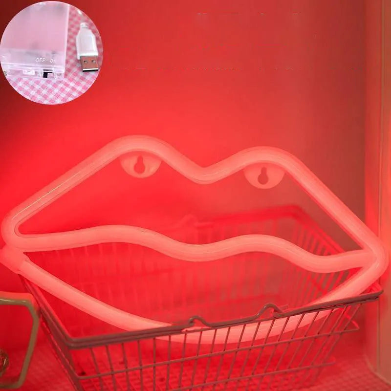 Pink lips-shaped neon light sign on wall with USB cable and battery backup