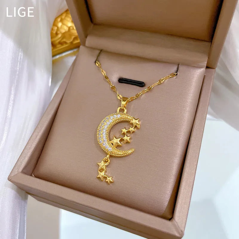 Geometric moon pendant necklace with crystals and tassel detail on an adjustable stainless steel chain.