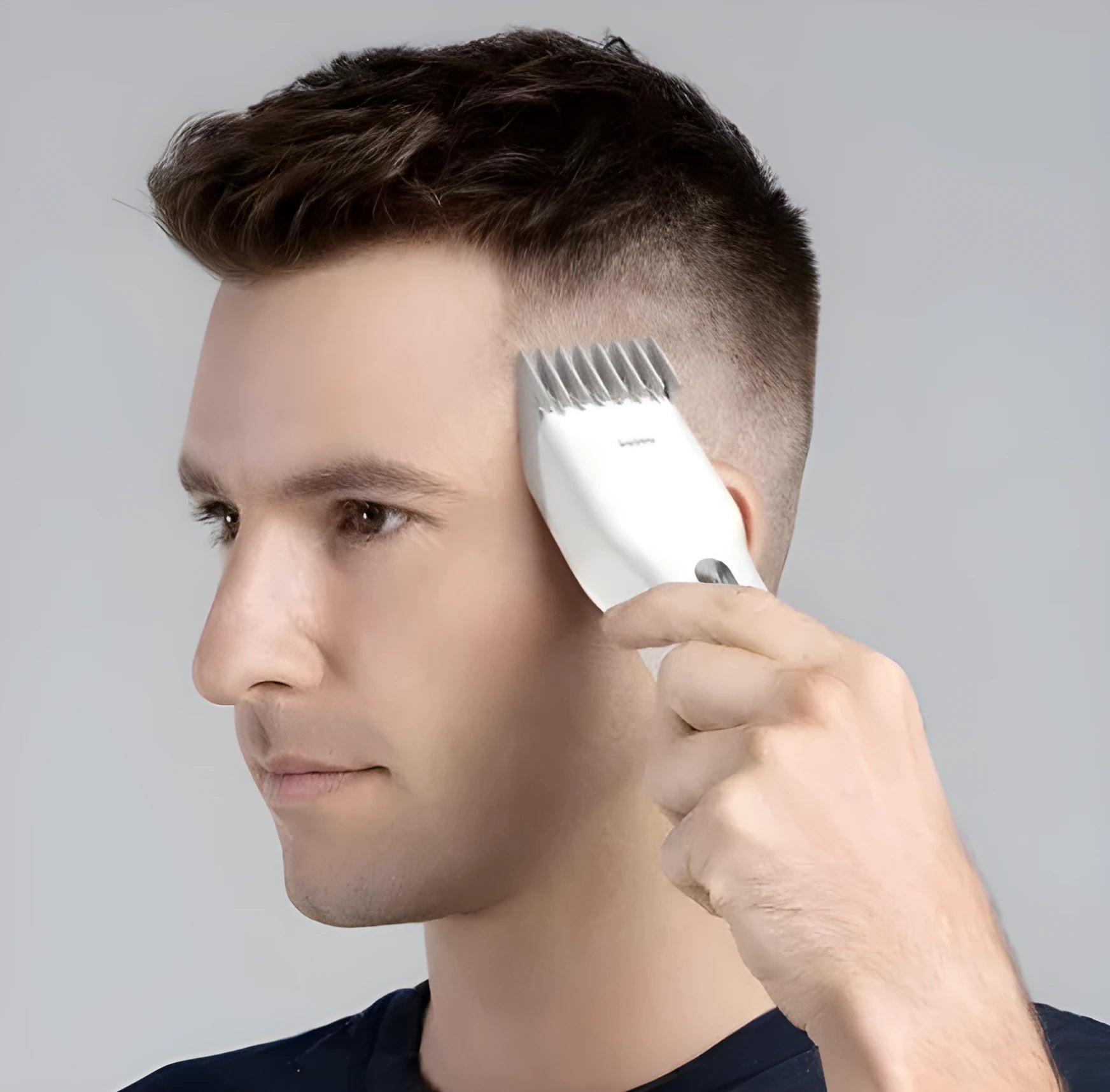 Black cordless hair clippers with ceramic cutter head and adjustable length comb for home barbering