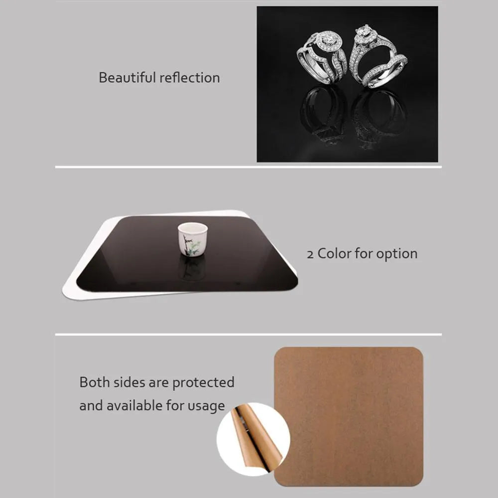 Square black and white acrylic shooting reflection boards for photography in three sizes on a table.