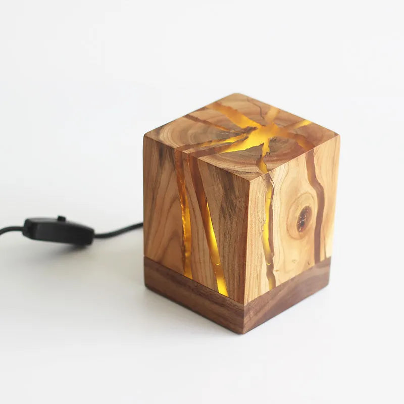 Creative crack night lamp in wood and PMMA with USB cable on bedside table