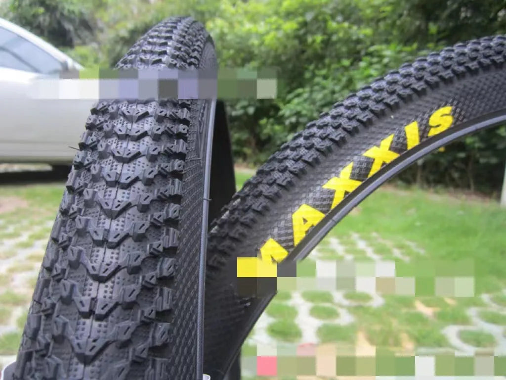 Ultralight mountain bike tyre with puncture-resistant tread, shown in a black and white sidewall style.