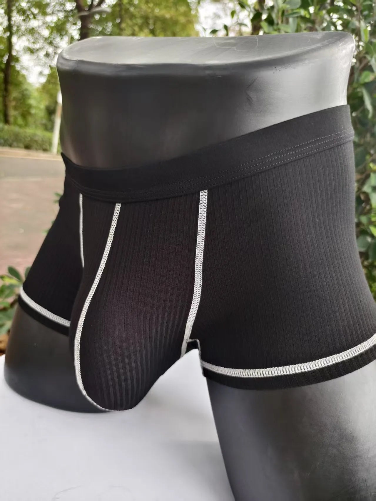 Men's solid colour breathable boxer shorts on a white background showing hip lifting design.