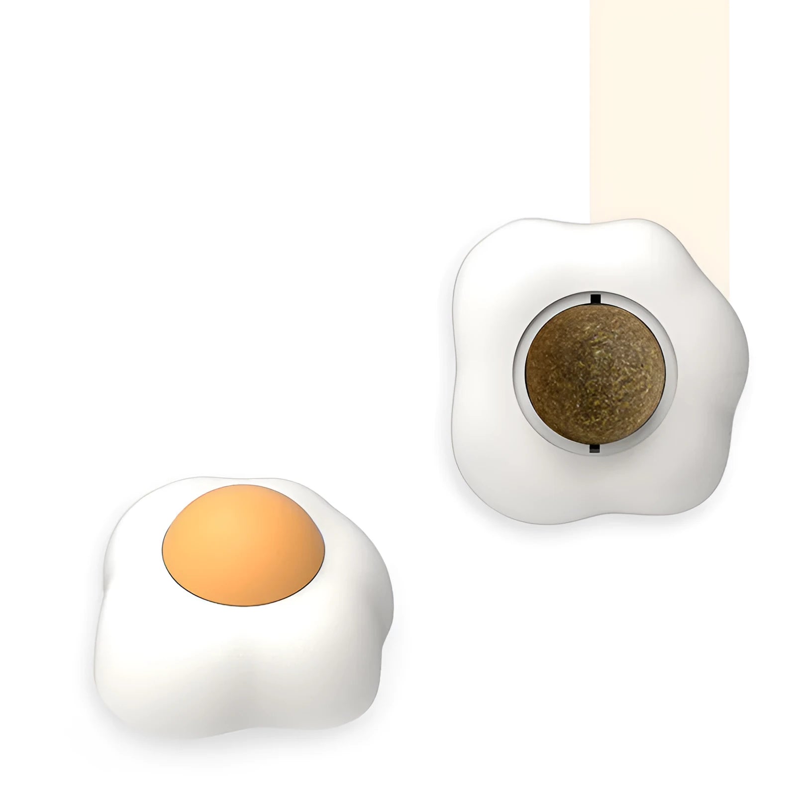 Catnip ball toy with adhesive backing attached to wall, showing cat head shape design