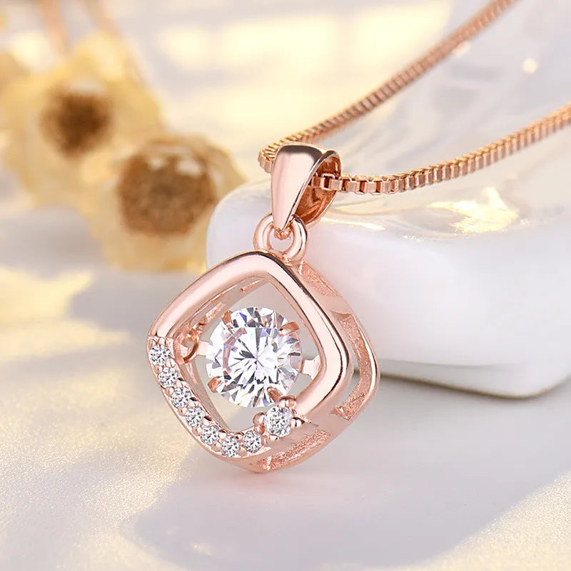 Silver heart pendant necklace with crown above and bow below on delicate chain