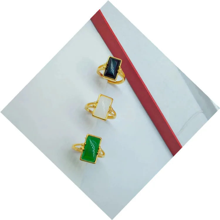 Gold-plated brass adjustable ring with a choice of black, green, or white gemstone inlays.