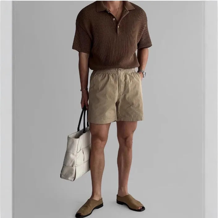 Cotton loose-fit sports shorts in black, shown on a model for summer athletic wear.