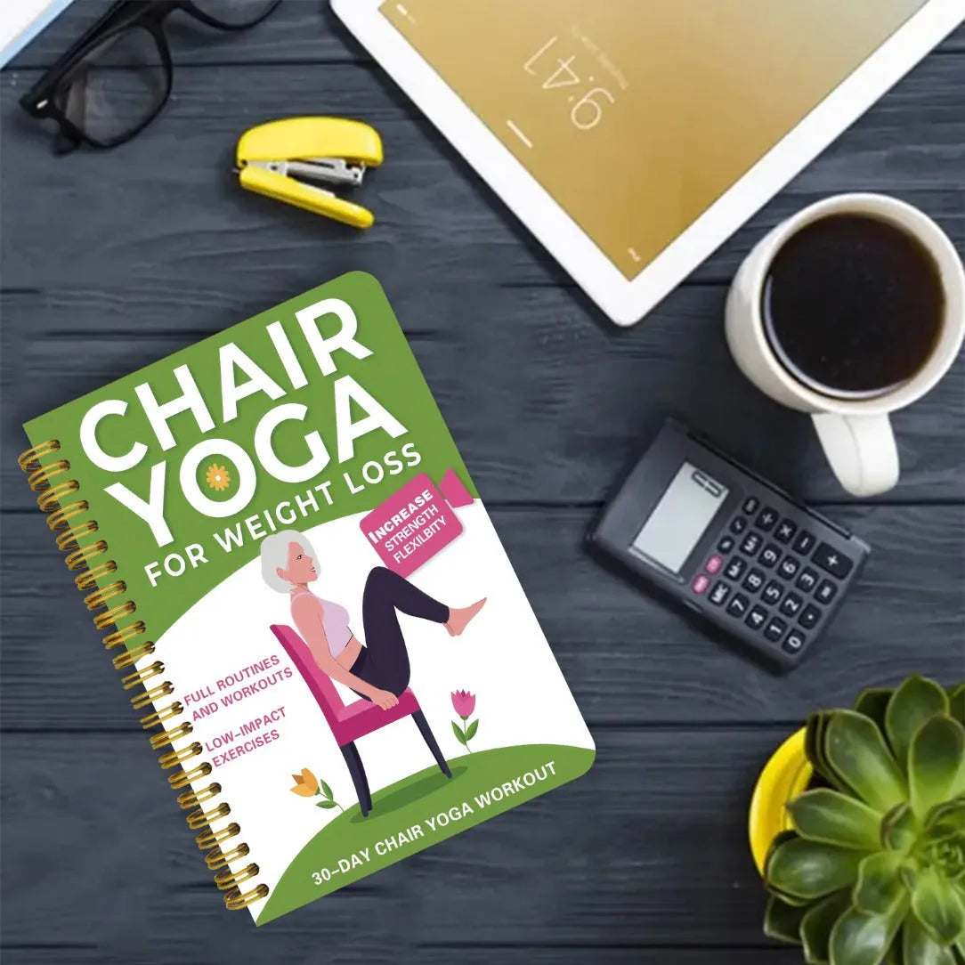 Green coil-bound 30 Days Chair Yoga Training Guide notebook lying open.