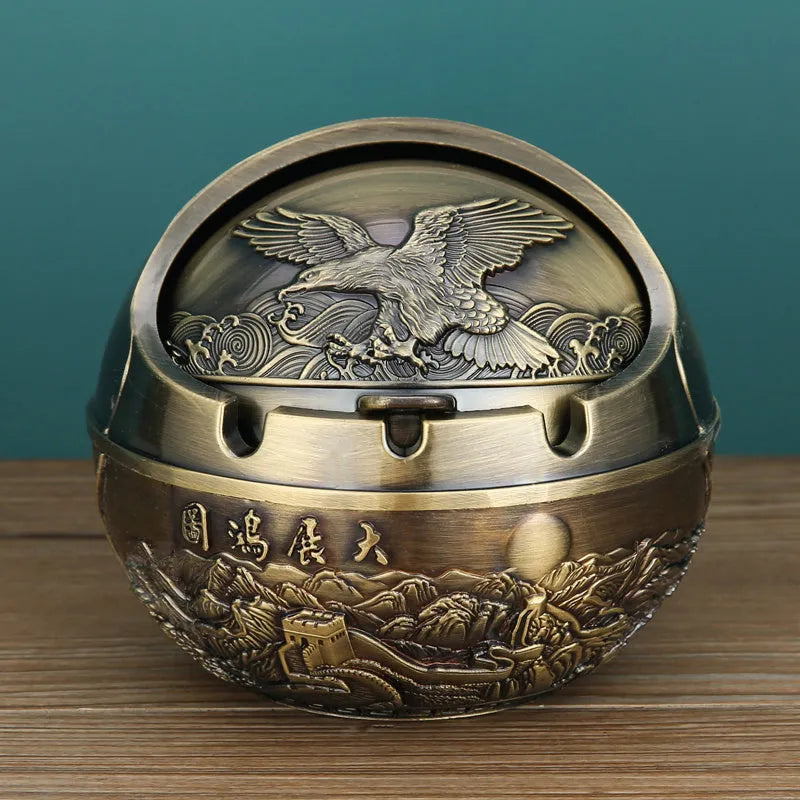 Bronze alloy ashtray with decorative fortune tree design and smoke extinguishing slot.