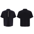 Loose-fit black men's polo t-shirt with a square collar and heavy sequin embroidery on the chest.