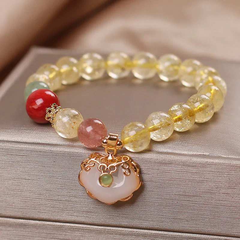 Women's adjustable alloy bracelet with a detailed natural citrine jade ruyi pendant in yellow tones.