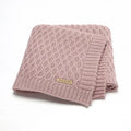 Solid colour acrylic infant blanket with textured lines, shown in a selection of colours including pink and grey.