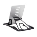 Black desktop card phone holder on a wooden desk next to a mobile phone and credit cards