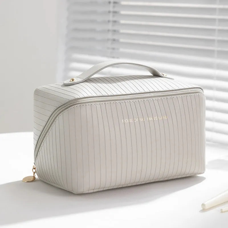 Vertical pattern pillow makeup bag in beige, black, brown, grey, or pink, showing cubic 22.5cm shape.