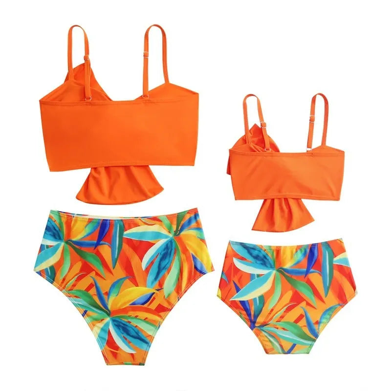 Women's big bow print bikini swim trunks set in bright colours on a mannequin.