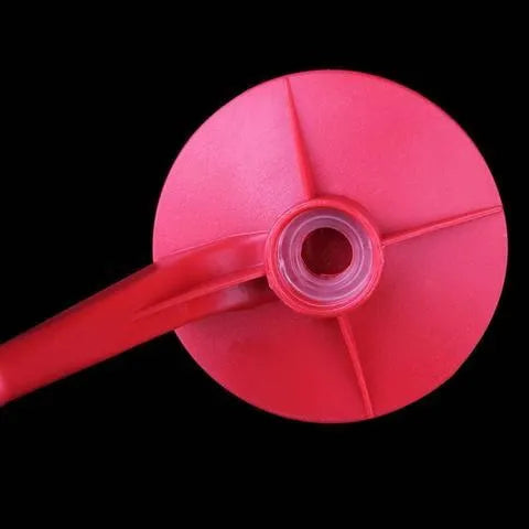 Red plastic Magic Tap soda dispenser attached to an inverted 2-litre bottle
