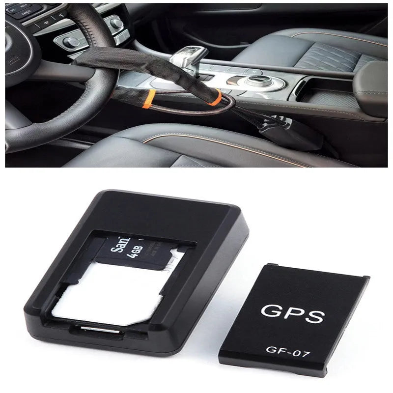 Small black magnetic GPS tracker device next to a USB charging cable on a table.