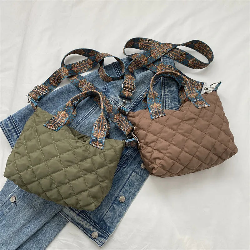 A soft Oxford cloth shoulder messenger bag in a horizontal square shape with embroidery detail.
