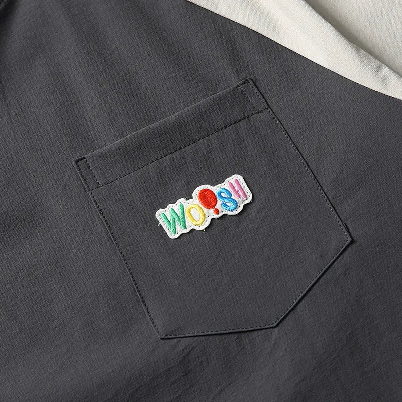 Dark grey men's t-shirt with contrast colour panels and raglan sleeves laid flat.