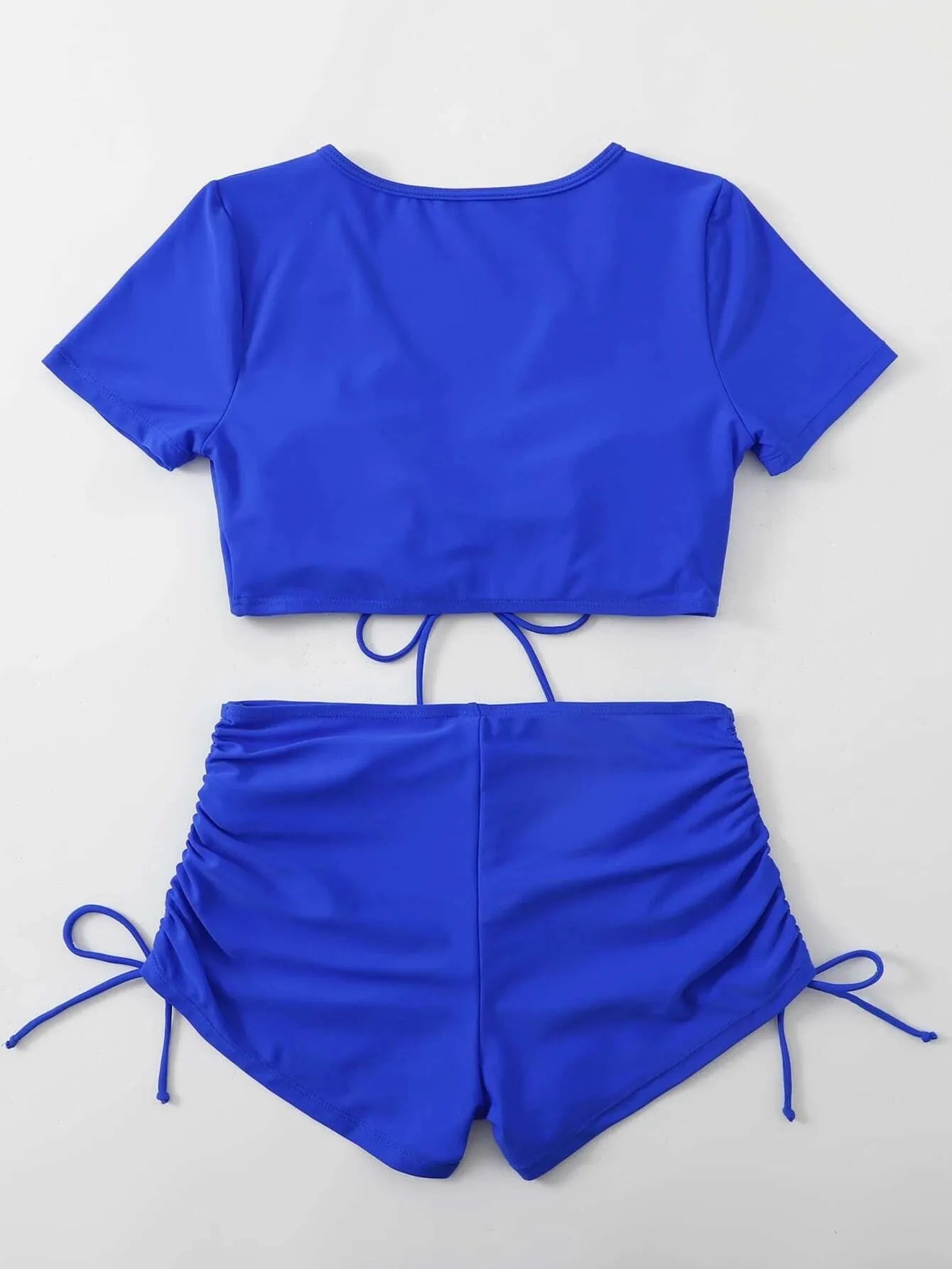Women's lace-up front swimsuit top with matching shorts in dark green.