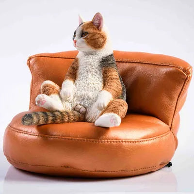 Lazy cat car ornament figure on fabric sofa, 7.5cm high resin model decoration.