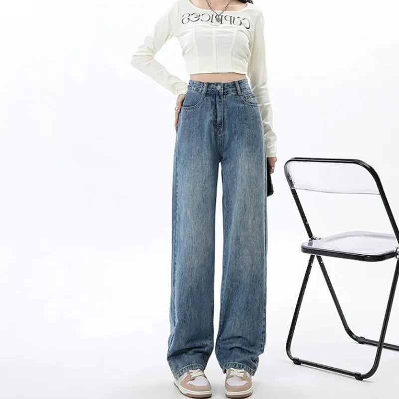 Woman wearing retro blue high-waisted wide-leg denim jeans with a straight-leg cut.