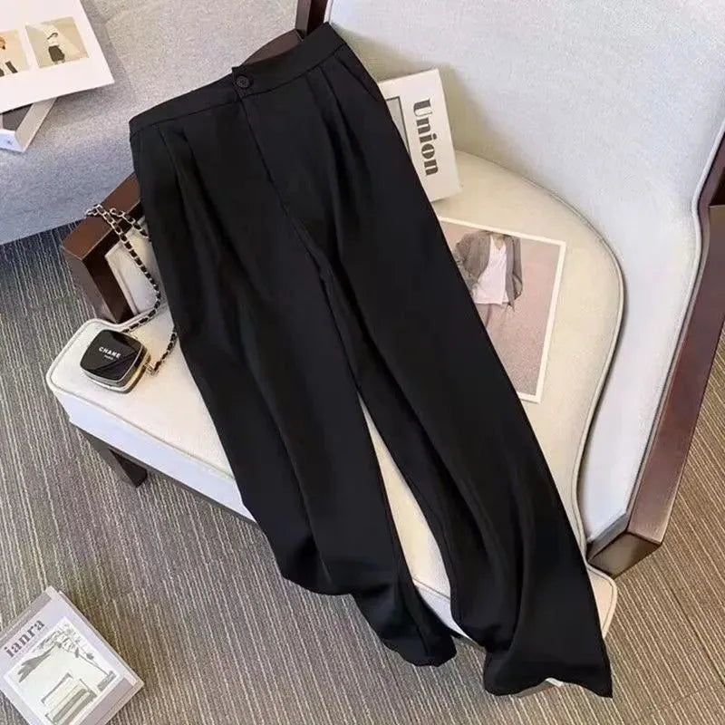 Women's loose fit polyester blouse in black on a hanger, showing regular sleeves and a front view.