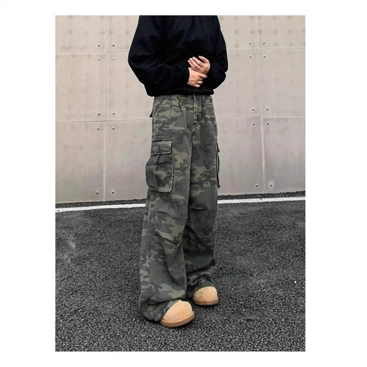 Men's loose-fit camouflage cargo pants with multiple pockets on a washed vintage-style fabric.