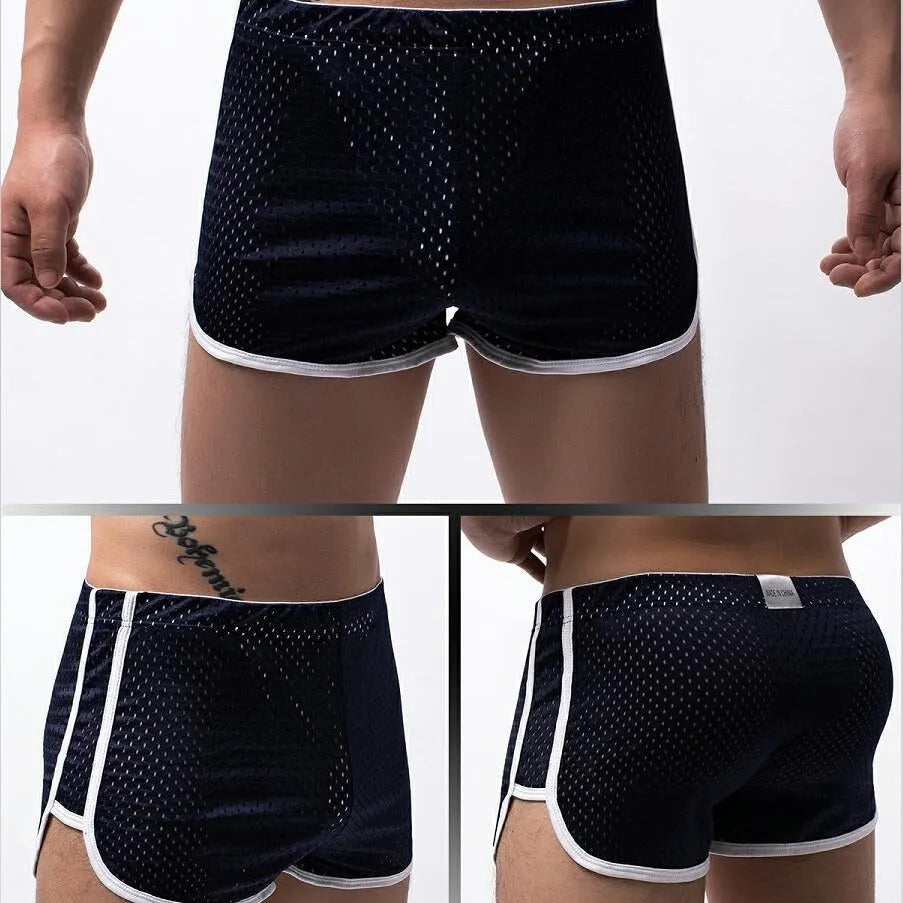 Men's grey cotton blend three-point boxer shorts laid flat, showing mid-waist design and knitted fabric texture.