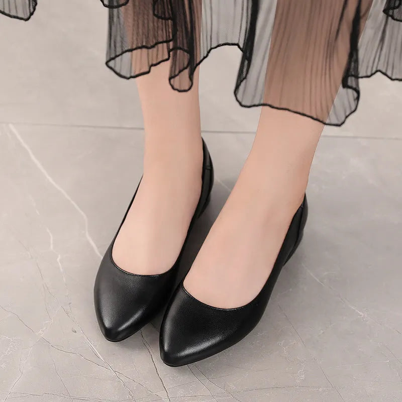 Beige low top casual shoes with pointed toe, buckle fastening, and a thick flat heel.
