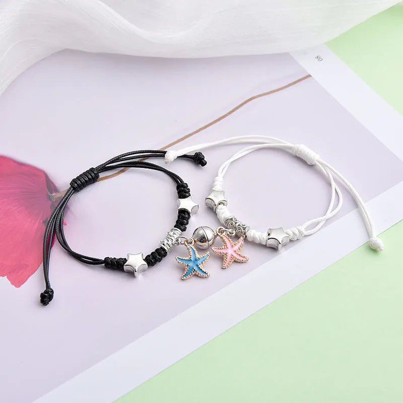 Magnet suction couple bracelets with alloy construction and various pendant designs including crowns and hearts