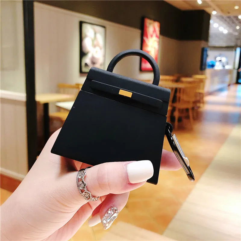 Silicone anti-drop earphone case for Apple AirPods 1 and 2 in black or orange, clamshell bag shape.