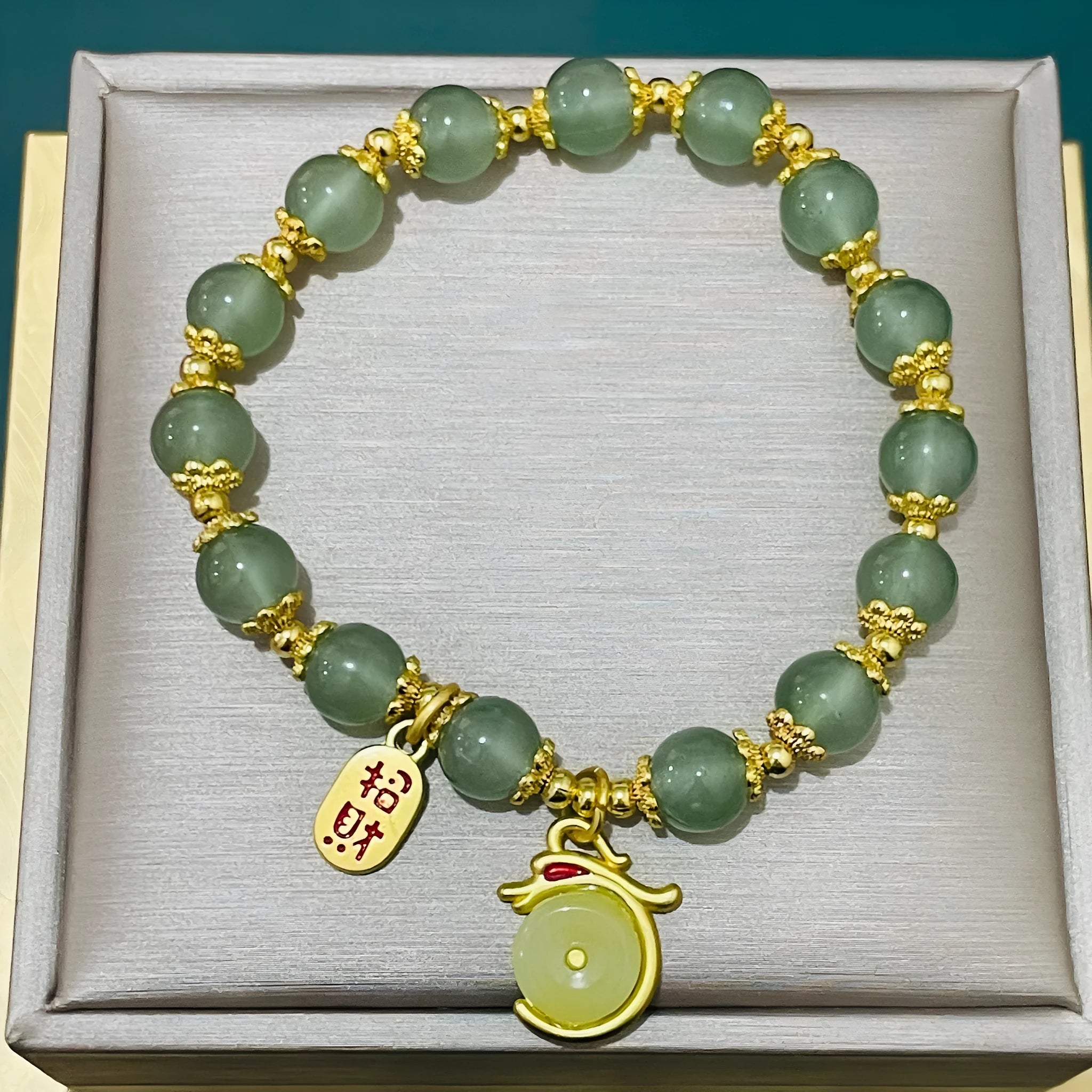 Manual crafted glass and coloured glaze bracelet with rabbit charm and silver peace buckle clasp on wrist.