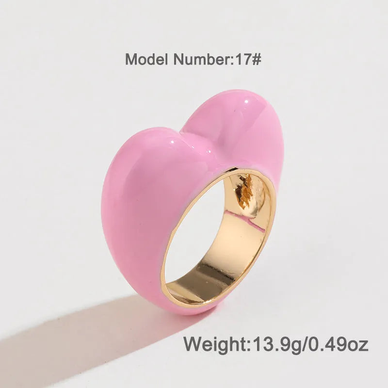 Heart-shaped zinc alloy enamel ring with three-dimensional colour detail in black, pink, purple, or red.