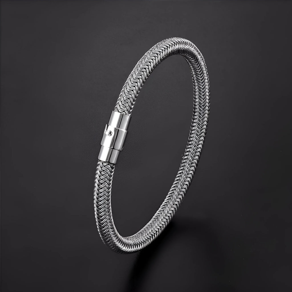 Geometric titanium steel wire bracelet with hidden magnetic clasp on a wrist, showing matte grey finish.