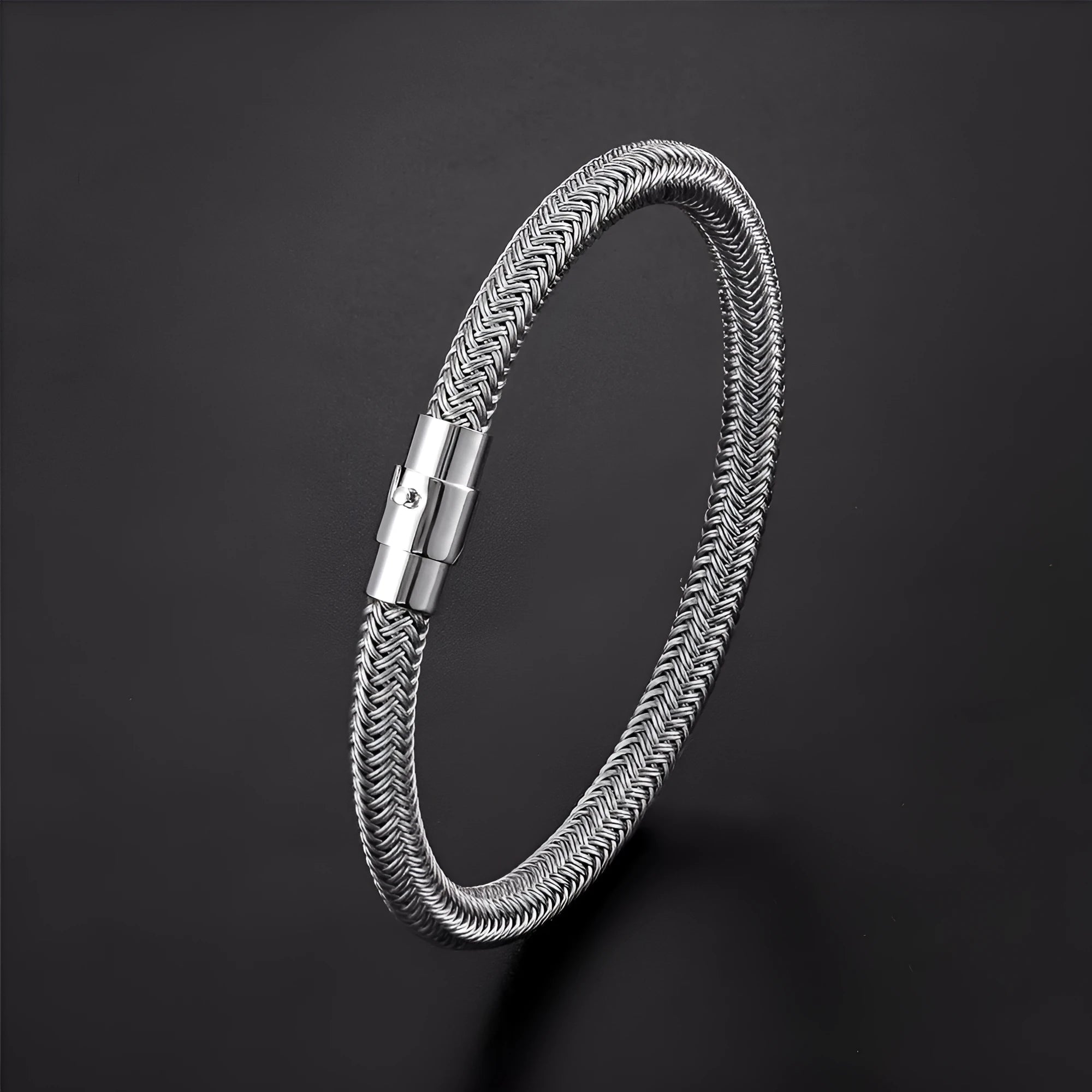Geometric titanium steel wire bracelet with hidden magnetic clasp on a wrist, showing matte grey finish.