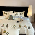 Cream Blue pure cotton duvet cover with raised white Christmas tree embroidery, paired with a fitted sheet and pillowcases.