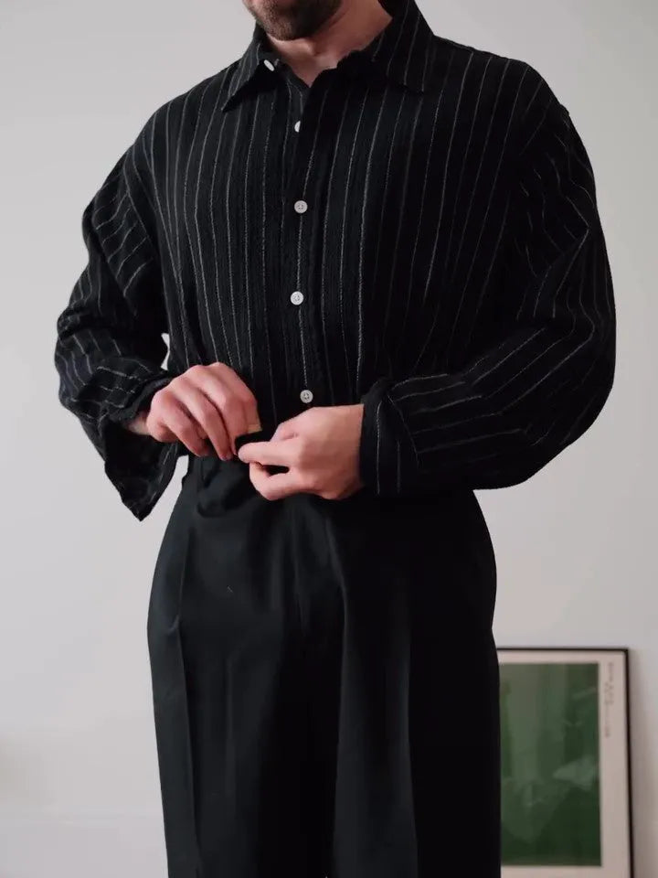 Black pinstriped button-down polyester shirt on a hanger, showing regular fit and striped pattern.