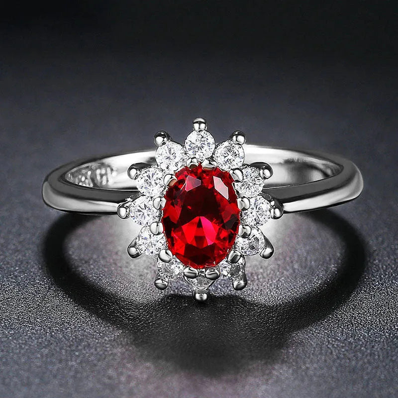 Copper floral women's ring with inlaid zirconia stone in green, blue, or red colour on a white background.